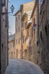 Wall Mural - old houses in narrow bending street, Volterra, Italy