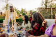 © Maskot - Male and female friends having fun while celebrating during dinner party in back yard