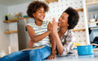 © NDABCREATIVITY - Happy african american single mother helping child with distance education. Online education