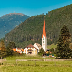 Church on a sunny summer day at Mieders, Stubaital valley, Innsbruck, Austria with Mount Patscherkofel in the background