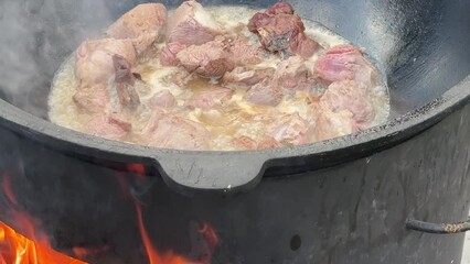 Sticker - Frying meat in a cauldron over a fire