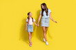 Photo of two girls enjoy free time together older sister hold hand younger isolated over bright color background