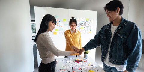 Wall Mural - ux developer and ui designer successful creative in smart casual wear discussing phone application d
