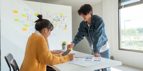 Wall Mural - ux developer and ui designer use augmented reality brainstorming about mobile app interface wirefram