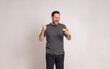 © Moon Safari - Shopaholic man holding credit card and screaming excitedly after winning rewards on white background