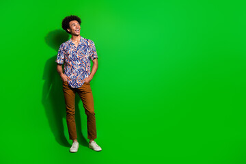 Sticker - Full body length photo of young student guy in trendy garment looking dreamy empty space brand outlet isolated on green color background