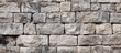 Texture background of aged granite stones parapet fragment close up Rough masonry surface