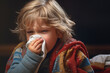 Sick boy or child blowing her nose or sneezing into handkerchief. Disease, illness, sickness, virus and treatment