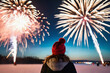 © Giuseppe Cammino - View from behind of a person admiring the fireworks on New Year's Eve