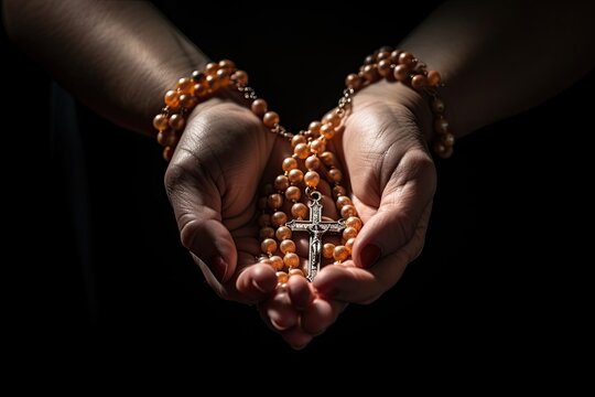 Praying hands holding a rosary Close up