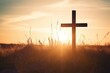 Silhouette christian cross on grass in sunrise background