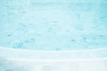 Wall Mural - Clear blue water in the pool, curved swimming pool. Step into the water and finish the pool bottom slab mosaic