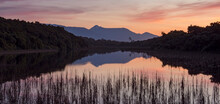 Sunset Over A Marsh With Mount Aspiring National Park In The Background; Haast, Ship Creek, South Island, New Zealand