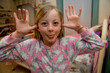 © Designpics - Girl in her bedroom getting ready for bed and making a silly face for the camera; Lincoln, Nebraska, United States of America