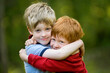 © Designpics - Two young boys embrace in a hug; Cross Lake, Minnesota, United States of America