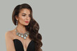 © millaf (Nemchinova) - Good-looking jewelry woman brunette fashion model with gold diamond earning and luxury necklace posing against gray studio wall banner background