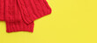 © Mariia - Red knitted scarf on a yellow background, top view, copy space. Christmas scarf, clothing, accessory