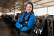 © Parilov - Portrait happy young woman veterinarian with phonendoscope on background barn with milk cows. Concept vet worker of livestock farm