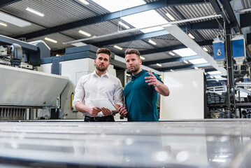 Sticker - Two men with tablet discussing on factory shop floor