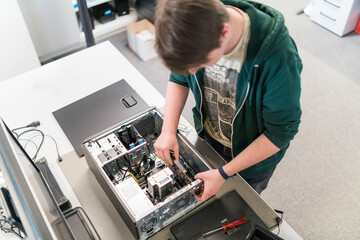 Teenager assembling personal computer