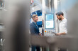 © tunedin - Two businessmen talking in a modern factory