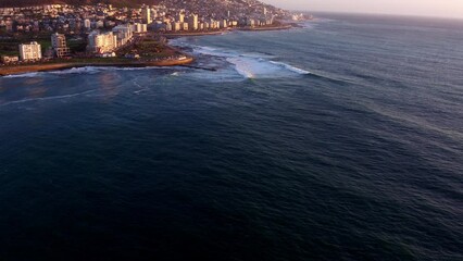 Wall Mural - Top view, city and beach with buildings, summer and waves with landscape, natural and Cape Town. Empty, ocean and water with buildings, urban town and nature with sunshine, seaside and mountains