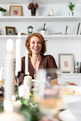 Portrait of a readheaded woman sitting at a dinner party