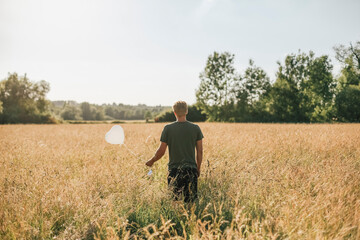 Wall Mural - Young man holding white heart shaped balloon