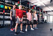 Group of fit seniors with personal trainer in gym