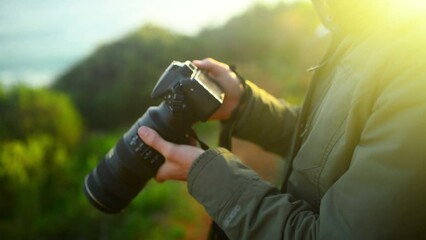 Wall Mural - Nature, hiking and man with camera for photography for landscape, natural environment and mountain. Photographer, adventure and person with tech for picture, travel blog and memories on holiday