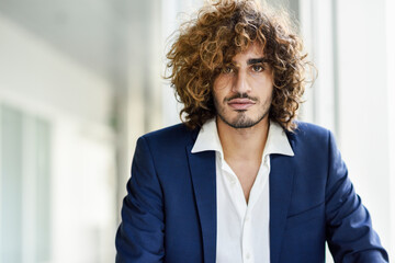 Wall Mural - Portrait of young businessman with beard and curly hair