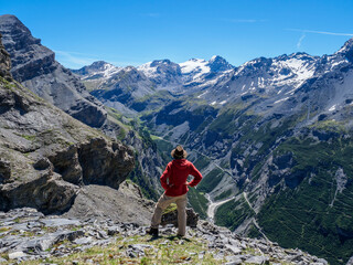 Wall Mural - Italy, Lombardy, Sondrio, hiker resting with view to Stelvio Pass and Ortler