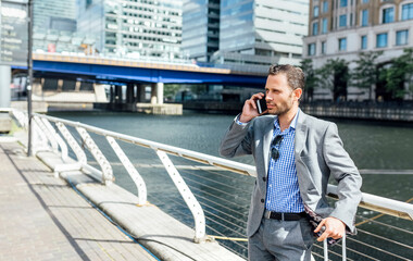 Poster - Businessman talking on the phone in the city