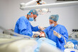 © tunedin - Dental surgeon and assistant work putting dental implant