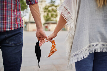 Poster - Close-up of couple with face mask holding hand on street in city