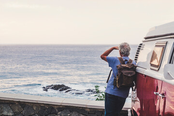 Poster - Senior man travelling in a vinatge van, looking at the sea, rear view