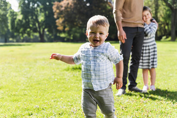 Wall Mural - Happy boy with family in a park