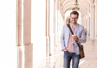 Poster - Smiling young man using smartphone