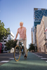 Wall Mural - Mature man riding bicycle in the city