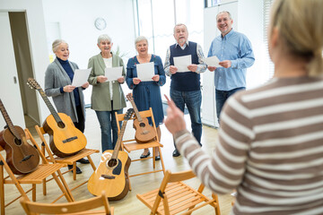 Wall Mural - Seniors in retirement home making music singing in choir