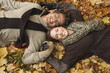 © Designpics - Portrait of Couple Lying Down in Autumn Leaves