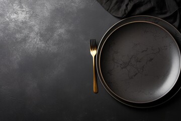 An empty black plate with cutlery on a dark concrete background. Home dinner cooking on stone table. Top view with copy space