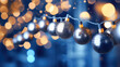 Holiday joy comes to life with the enchanting bokeh lights from a Christmas garland on a dark blue backdrop.