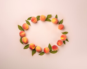 Wall Mural - Round frame of peaches on pink background, spring card design template. Healthy fresh vitamin food concept. Copy space, flat lay style, frame