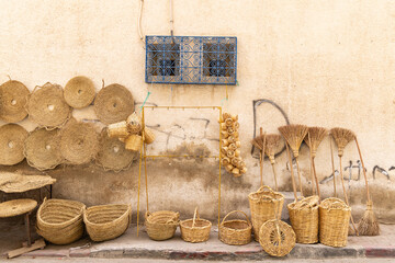 Wall Mural - Woven baskets and brooms for sale at the outdoor souk in Bir al Haffay.