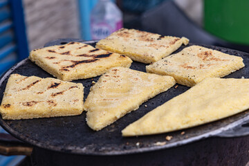 Wall Mural - Flat bread being grilled at an outdoor market.