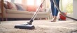 Defocused photo of a person vacuuming a carpeted floor, with the vacuum cleaner and the carpet in focus, illustrating the removal of dust and allergens during spring cleaning, 
