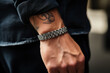 © Keitma - Man wearing a steel bracelet , male jewelry concept image