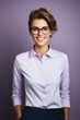 © Instacraft.Studio - Smiling confident stylish young woman standing in startup workspace wearing purple shirt