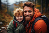 Fototapeta  - cheerful bearded man with redhead son looking at camera, happy family trip